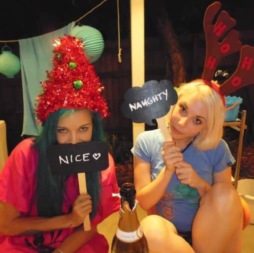 Girls Holding Blackboard Speech Bubble Props On Sticks