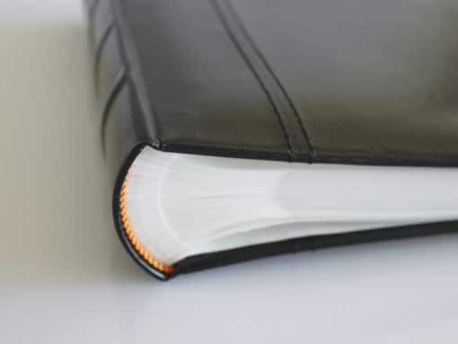 Close Up Of Spine Of Black Leather 200 Album Slip-In