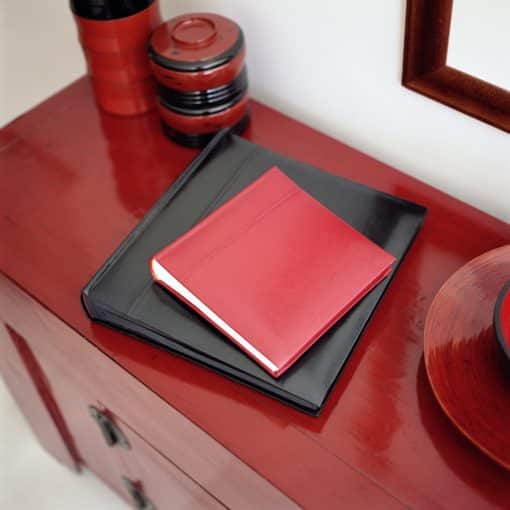 Red and Black Leather Photo Albums on Table